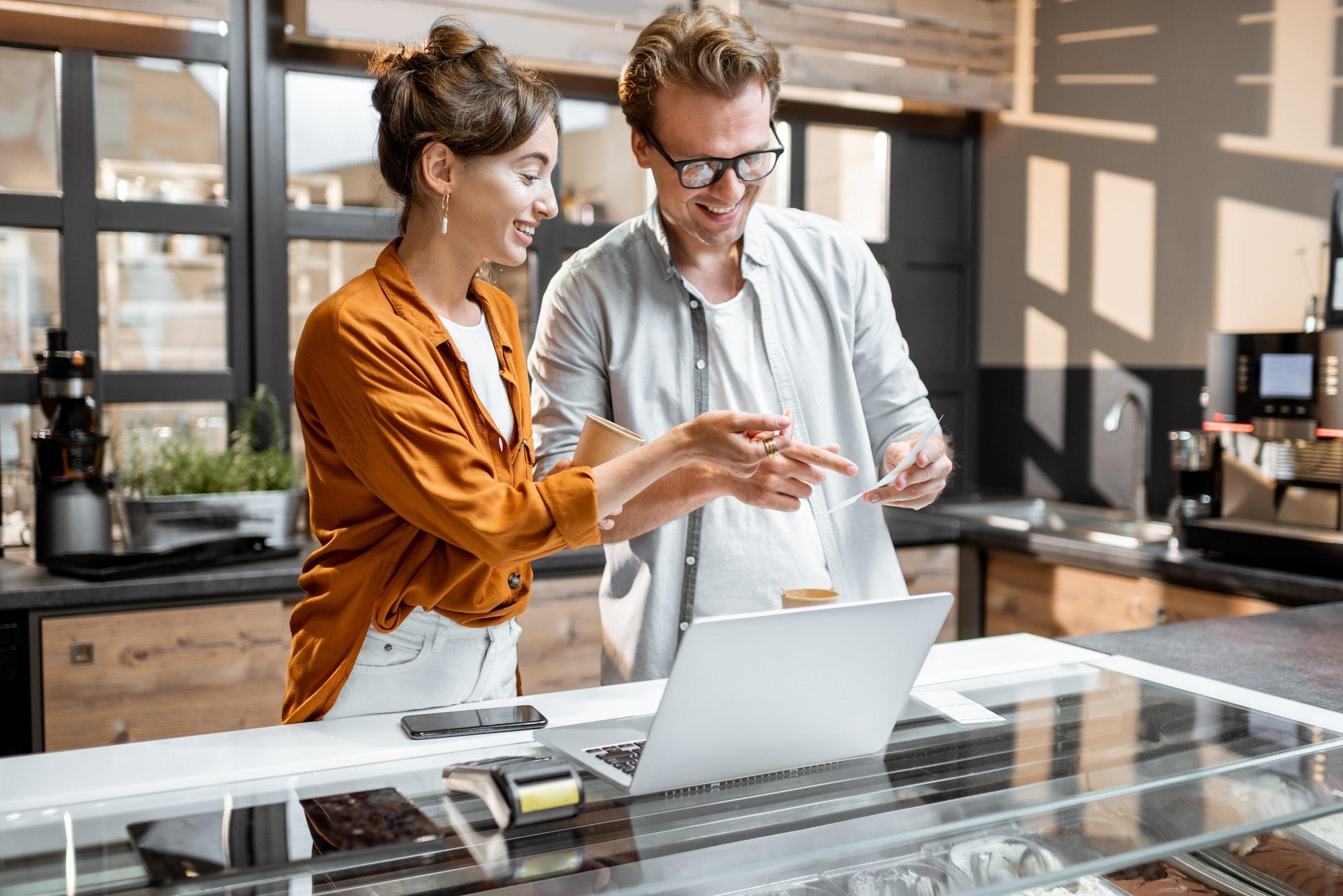 Man and woman managing business at the cafe or small shop